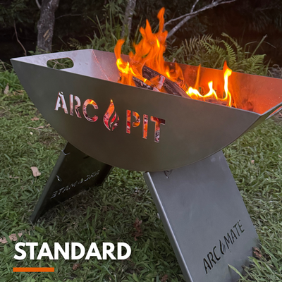 ArcPit fire pit with flames on a grassy background